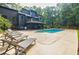Backyard pool with plenty of lounge chairs, an outdoor grill, and lush green trees for shade and privacy at 1510 Chevron Dr, Sandy Springs, GA 30350