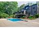 Stunning backyard oasis featuring a pool, diving board, deck, and lounge chairs for relaxing and entertaining at 1510 Chevron Dr, Sandy Springs, GA 30350