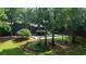 Spacious backyard featuring a modern home, a well-maintained pool, and ample greenery and mature trees at 1510 Chevron Dr, Sandy Springs, GA 30350