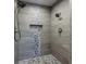 Modern shower featuring stylish tile work, dual showerheads, and a built-in niche at 1510 Chevron Dr, Sandy Springs, GA 30350