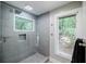 Modern tiled shower featuring a window offering natural light and a built-in niche for storage at 1510 Chevron Dr, Sandy Springs, GA 30350
