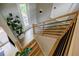 Modern staircase with wooden treads, black metal railings, and natural light at 1510 Chevron Dr, Sandy Springs, GA 30350