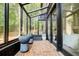 Bright sunroom with brick flooring, offering a tranquil space with views of the outdoors at 1510 Chevron Dr, Sandy Springs, GA 30350