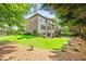 Expansive backyard with lush lawn, mature trees, and a large deck perfect for outdoor entertaining at 2953 Kings Walk Ave, Marietta, GA 30062