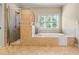 Well-lit bathroom featuring a separate shower and tub, and a window with natural light at 2953 Kings Walk Ave, Marietta, GA 30062