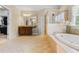 Bright bathroom with soaking tub, glass shower, dual vanity, and tile floors at 2953 Kings Walk Ave, Marietta, GA 30062