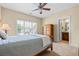 Cozy bedroom with a large window, ceiling fan, and neutral color scheme, offers a comfortable retreat at 2953 Kings Walk Ave, Marietta, GA 30062