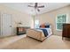 Comfortable bedroom with neutral tones, a ceiling fan, and windows offering natural light at 2953 Kings Walk Ave, Marietta, GA 30062