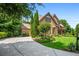 An exterior view of a brick house with a well manicured front yard and long driveway at 2953 Kings Walk Ave, Marietta, GA 30062