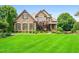 Beautiful exterior front view of a brick house with green lawn, shrubbery and mature trees at 2953 Kings Walk Ave, Marietta, GA 30062