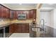 Modern kitchen with dark wood cabinetry, granite countertops, and stainless steel appliances at 2953 Kings Walk Ave, Marietta, GA 30062