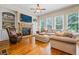 Comfortable living room with stone fireplace, built-in shelving, hardwood floors, and abundant natural light at 2953 Kings Walk Ave, Marietta, GA 30062
