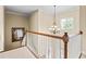 Elegant staircase featuring carpeted steps, white railings, and a stylish chandelier above at 2953 Kings Walk Ave, Marietta, GA 30062