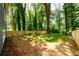 Large, fenced backyard featuring mature trees providing ample shade and privacy for outdoor enjoyment at 387 Hillside Sw Dr, Atlanta, GA 30310