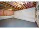 Spacious unfinished basement featuring white walls and pink insulation awaiting personalization and finishing touches at 387 Hillside Sw Dr, Atlanta, GA 30310