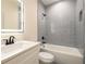 Updated bathroom featuring subway tile, matte black hardware, a shower/tub, vanity with sink, and LED backlit mirror at 387 Hillside Sw Dr, Atlanta, GA 30310
