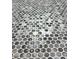 Close-up of bathroom tile featuring a mosaic of round, multicolored tiles in shades of gray, white, and blue at 387 Hillside Sw Dr, Atlanta, GA 30310