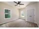 Bright bedroom features neutral tones, two windows with views, a modern ceiling fan, and closet with double doors at 387 Hillside Sw Dr, Atlanta, GA 30310