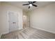 Empty bedroom features neutral carpet, a ceiling fan, and a spacious closet at 387 Hillside Sw Dr, Atlanta, GA 30310