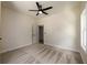 Well-lit bedroom features neutral walls, patterned carpeting, a modern ceiling fan, and a doorway leading to an adjacent room at 387 Hillside Sw Dr, Atlanta, GA 30310