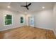 Spacious bedroom with a tray ceiling, recessed lights, hardwood floors, and an ensuite bathroom at 387 Hillside Sw Dr, Atlanta, GA 30310