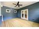 Relaxing covered porch features wood flooring, a ceiling fan, recessed lights, and views of the outdoors at 387 Hillside Sw Dr, Atlanta, GA 30310