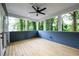 Enclosed porch with wood flooring, ceiling fan, and beautiful views of the green foliage outdoors at 387 Hillside Sw Dr, Atlanta, GA 30310