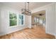 Bright dining area with hardwood floors, stylish chandelier, and views of the backyard at 387 Hillside Sw Dr, Atlanta, GA 30310