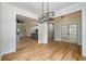 Spacious dining room with wood floors, modern lighting, and an open layout perfect for entertaining at 387 Hillside Sw Dr, Atlanta, GA 30310