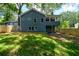 Backyard view of the home showcasing a covered porch, deck, and fenced-in yard at 387 Hillside Sw Dr, Atlanta, GA 30310