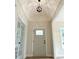 Inviting foyer with a stylish light fixture, neutral walls, and a view of the front door at 387 Hillside Sw Dr, Atlanta, GA 30310