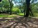 Spacious green space surrounded by mature trees provides a peaceful and inviting outdoor setting at 387 Hillside Sw Dr, Atlanta, GA 30310