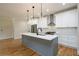 Beautiful kitchen with stainless steel appliances, subway tile backsplash, and gray island with pendant lighting at 387 Hillside Sw Dr, Atlanta, GA 30310