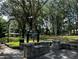 Entrance to Emma Millican Park is framed by stone walls, showcasing a canopy of mature trees at 387 Hillside Sw Dr, Atlanta, GA 30310