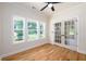 Bright sunroom features three large windows offering an abundance of natural light and beautiful hardwood floors at 387 Hillside Sw Dr, Atlanta, GA 30310