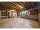Spacious unfinished basement featuring exposed framing, concrete walls, and several windows for natural light at 387 Hillside Sw Dr, Atlanta, GA 30310