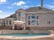 Backyard featuring in-ground pool and adjacent patio with covered seating and cascading water feature at 5009 Kingsley Manor Ct, Marietta, GA 30066