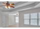 Bedroom featuring tray ceiling, ceiling fan, and large windows at 5009 Kingsley Manor Ct, Marietta, GA 30066