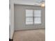 Cozy bedroom with a ceiling fan and a window, featuring neutral carpet flooring at 5009 Kingsley Manor Ct, Marietta, GA 30066