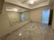 A compact bedroom with tiled floor, ceiling fan, closet, and wall mirror at 5009 Kingsley Manor Ct, Marietta, GA 30066