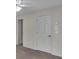 Bedroom featuring a door, neutral carpet, and visible thermostat on the wall at 5009 Kingsley Manor Ct, Marietta, GA 30066