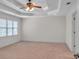 Spacious bedroom with tray ceiling, ceiling fan, neutral carpet and natural light at 5009 Kingsley Manor Ct, Marietta, GA 30066