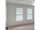 Bright bedroom with two windows offering plenty of natural light and neutral carpet flooring at 5009 Kingsley Manor Ct, Marietta, GA 30066