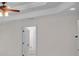 Bedroom featuring tray ceiling, ceiling fan, and adjacent doorway at 5009 Kingsley Manor Ct, Marietta, GA 30066