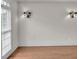 Empty room featuring hardwood floors, a large window, and decorative sconces at 5009 Kingsley Manor Ct, Marietta, GA 30066