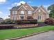 Charming two-story brick home with a landscaped front yard and manicured shrubbery at 5009 Kingsley Manor Ct, Marietta, GA 30066