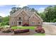 Beautiful brick home featuring manicured landscaping, a well-maintained lawn, and an inviting entrance at 5009 Kingsley Manor Ct, Marietta, GA 30066
