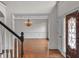 Foyer showcasing hardwood floors, chandelier, and decorative molding leading to dining room at 5009 Kingsley Manor Ct, Marietta, GA 30066
