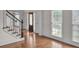 Foyer with hardwood floors and staircase featuring white trim and a black handrail at 5009 Kingsley Manor Ct, Marietta, GA 30066