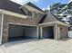 Three-car garage with painted floor and brick exterior under blue sky at 5009 Kingsley Manor Ct, Marietta, GA 30066